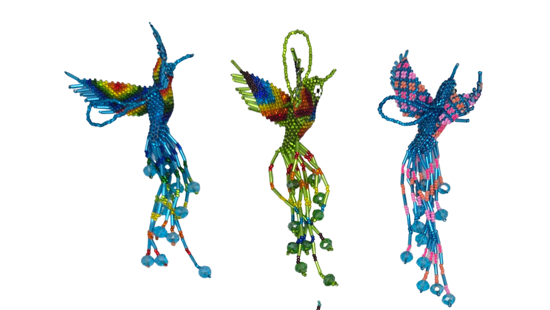 Colorful beaded hummingbird ornaments on a white background


