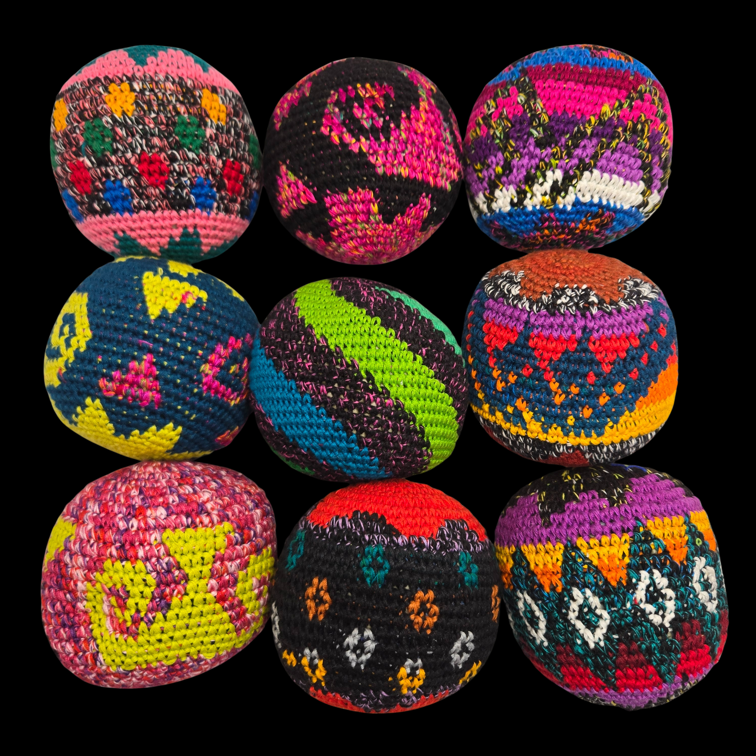 Colorful crocheted balls with geometric patterns on a black background