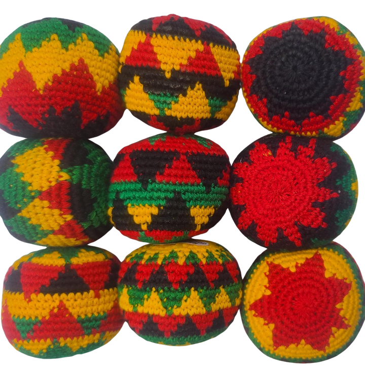 Colorful crocheted footbag hacky sacks in rasta colors geometric patterns on a white background