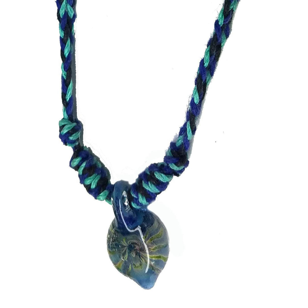 Close-up of blue-green teardrop pendant, visible lampwork mushroom, braided cord knots, hand blown glass mushroom necklace