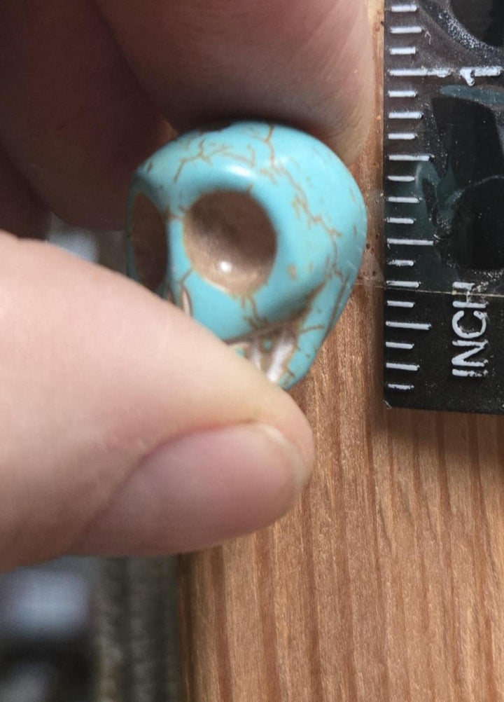 Close macro with ruler, single turquoise-style carved skull bead about 10mm, beads for jewelry making, bulk skull beads